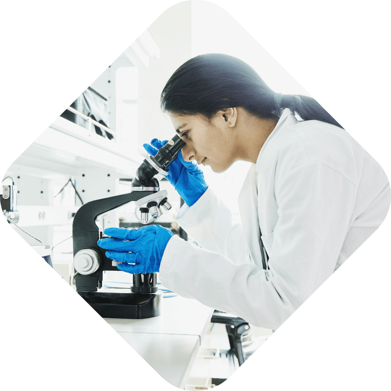 Female researcher looking into microscope